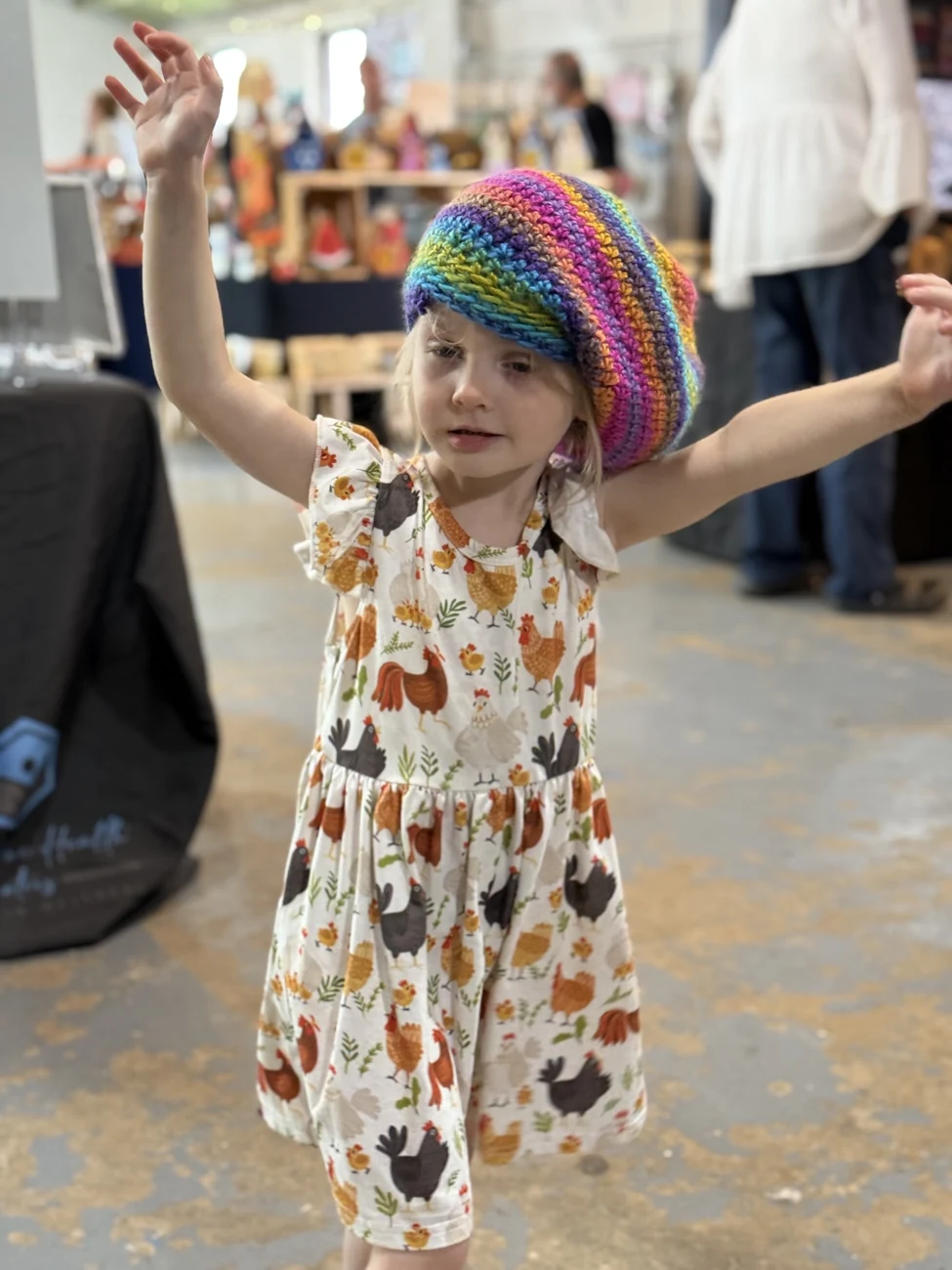 Child wearing a rainbow hat